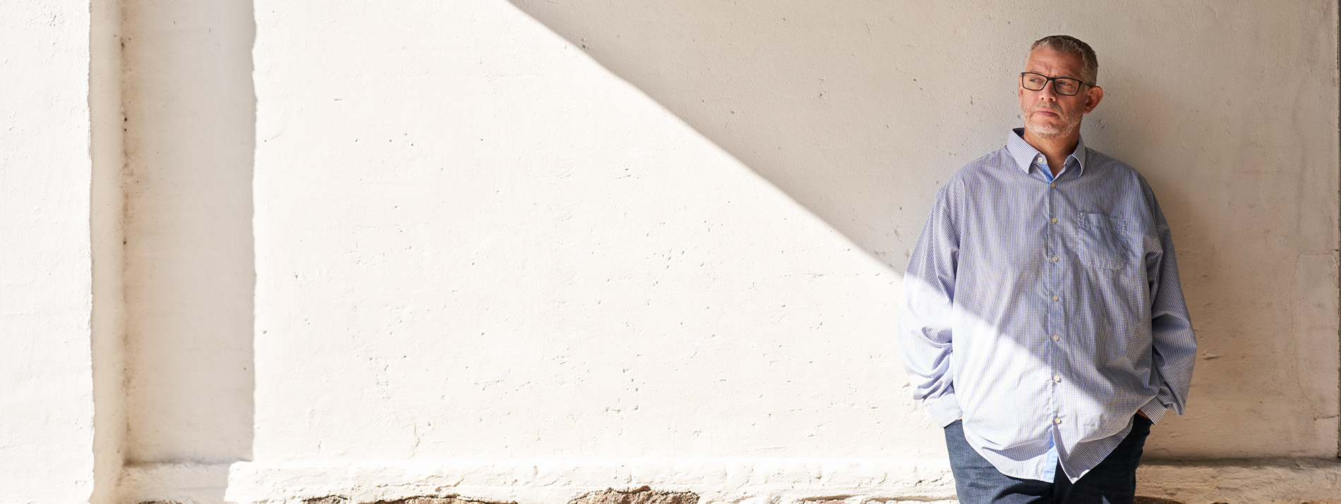Three women walking together outdoors on a sunny day, enjoying each other’s company.