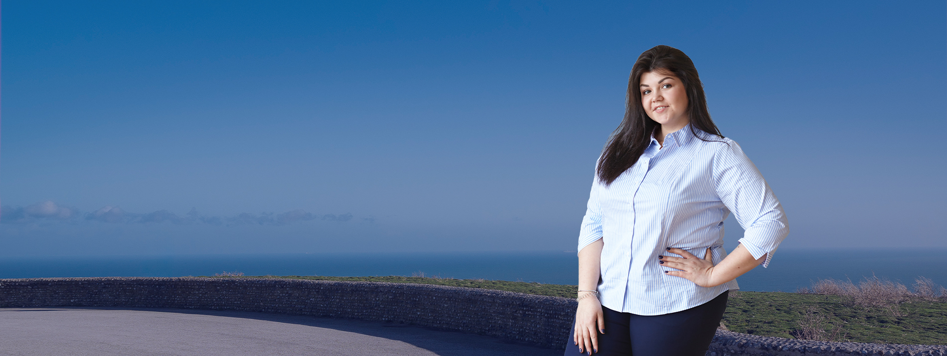 Three women walking together outdoors on a sunny day, enjoying each other’s company.
